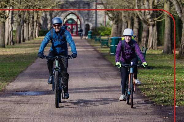 Two people riding e-bikes